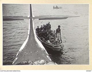 NANTAMBU, NEW BRITAIN, 1945-08-22. TROOPS OF C COMPANY, 37/52ND INFANTRY BATTALION, ARRIVING BY LAUNCH ALONGSIDE A ROYAL NEW ZEALAND AIR FORCE CATALINA AIRCRAFT. THE BATTALION WAS AIRLIFTED BACK TO ..