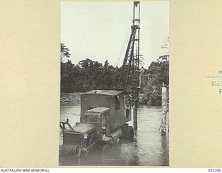 BOUGAINVILLE. 1945-04-23. A 15 FIELD COMPANY, ROYAL AUSTRALIAN ENGINEERS, MOBILE PILE DRIVER WORKING IN THE PURIATA RIVER DURING THE CONSTRUCTION OF A PANEL BRIDGE TO REPLACE A TEMPORARY ..