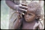 Western Highlands: young child clings to a woman's hand