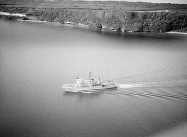 An elevated port view of the salvage and rescue ship USS BRUNSWICK (ATS 3) entering the harbor