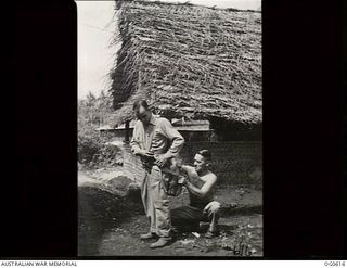 VIVIGANI, GOODENOUGH ISLAND, PAPUA. C. 1943-10. OUTSIDE THE THATCHED ROOF HUT OF NO. 30 BEAUFIGHTER SQUADRON RAAF, PARACHUTE SECTION. SNUG ADJUSTMENT OF A PARACHUTE IS NECESSARY NOT ONLY FOR THE ..