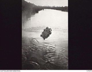 CAPE CROISELLES, ? NEW GUINEA. ? 1944-03. CAMOUFLAGED JAPANESE BARGE BEING STRAFED IN RIVER