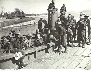 1943-09-22. NEW GUINEA. AUSTRALIAN TROOPS CAPTURE LAE. WRECKED JAPANESE BARGES AT LAE