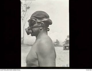 VIVIGANI, GOODENOUGH ISLAND, PAPUA NEW GUINEA. C. 1943-09. 37603 LEADING AIRCRAFTMAN A. J. WHYTE OF KINBOMBI, QLD, A POWDER MONKEY OF NO. 7 MOBILE WORKS SQUADRON RAAF, WEARING PROTECTIVE GOGGLES ..