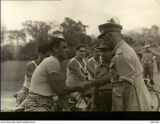 Torokina, Bougainville. 1945-11-03. Major General W. Bridgeford, CBE CB MC, General Officer Commanding 3 Australian Division, congratulating NX147348 Private J. Walsh on his victory in the sprint ..