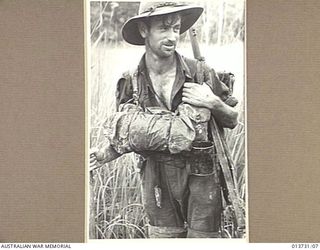 1942-12-04. NEW GUINEA. GONA. TYPICAL AUSTRALIAN WHO IS FIGHTING IN THE GONA AREA. THIS PHOTO WAS TAKEN LESS THAN 100 YARDS FROM THE JAPANESE POSITIONS. (NEGATIVE BY G. SILK)