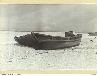 WANDOKAI, NEW GUINEA. 1944-01-01. A WRECKED JAPANESE BARGE ON THE BEACH