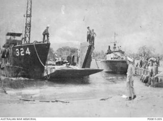 TOROKINA, EMPRESS AUGUSTA BAY, BOUGAINVILLE ISLAND. 1944. LANDING CRAFT TANK NO. 324 AND A PATROL BOAT AT THE BEACH. (DONOR A. BARING)