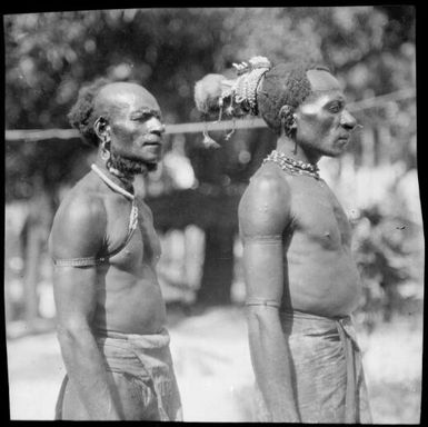 Two Ramu Delta men in profile, one is wearing a cuscus fur headdress, Awar, Sepik River, New Guinea, 1935, 2 / Sarah Chinnery