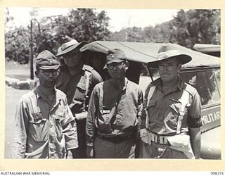 Two suspected Japanese war criminals returning to their camp under provost guard after having been interrogated by an Australian intelligence officer at Headquarters 11 Division. Identified, far ..