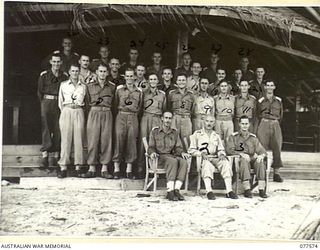 OFFICERS OF THE 27TH INFANTRY BATTALION OUTSIDE THEIR MESS BEFORE THE COMMENCEMENT OF THEIR WEEKLY FORMAL MESS DINNER. IDENTIFIED PERSONNEL ARE:- NX107713 MAJOR S.W. PICKETT (1); SX2930 ..