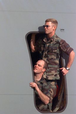 Two members of the Red Horse Air National Guard, Rickenbacker Air National Guard Base, Columbus, Ohio, get their first look at Andersen Air Force Base, Guam, as they wait to disembark. They have come with 45 others of their unit to help in the housing relief effort after Super Typhoon Paka