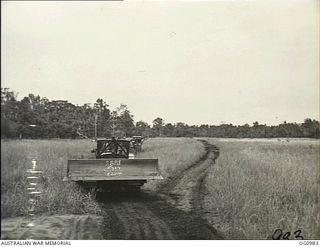 AITAPE, NORTH EAST NEW GUINEA. C. 1944-04. NO. 7 MOBILE WORKS SQUADRON RAAF GOES INTO ACTION WITH GRADERS, AND OTHER HEAVY EQUIPMENT WHICH WERE LANDED WITH THE INVASION FORCES AT KORAKO VILLAGE