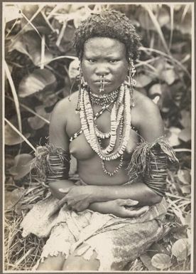 Ambasi types [seated girl wearing necklaces and armbands] Frank Hurley