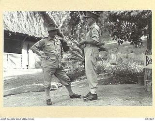 Port Moresby, New Guinea. 4 May 1944. NX12346 Brigadier John Walter Main CBE ED (1), Chief Engineer, Headquarters New Guinea Force, speaking with NX34728 Brigadier J. R. Broadbent CBE (2), outside ..