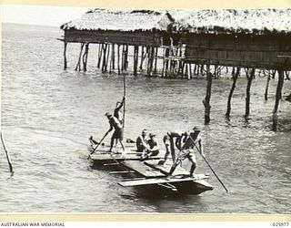 PORT MORESBY, PAPUA. 1942-07-20. PUNTING THEIR "LAKATOI", (NATIVE NAME FOR A SAILING CRAFT) THESE AUSTRALIAN SOLDIERS PUSH OUT THROUGH THE SHALLOWS ON A FISHING EXCURSION. THE NATIVE SAILING CRAFT ..