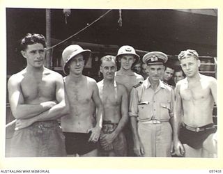 RABAUL, NEW BRITAIN. 1945-09-30. SALVAGE OFFICER, CAPTAIN MCDONALD, CAPTAIN OF THE CAMBRIAN SALVOR, OPERATED BY COMMONWEALTH SALVAGE BOARD, WITH HIS TEAM OF DIVERS. THEY ARE CURRENTLY WORKING ON ..