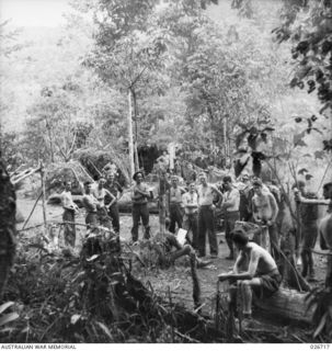 PAPUA. 1942-09. MEN OF THE 2/16TH INFANTRY BATTALION RESTING IN A SMALL CLEARING IN THE JUNGLE AFTER THE FIRST STAGES OF THE CAMPAIGN WHEN THEY WERE FORCED BACK BY THE JAPS