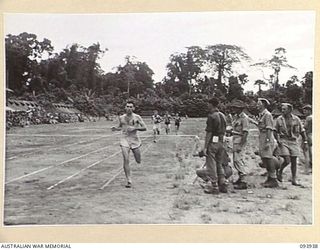 TOROKINA, BOUGAINVILLE, 1945-07-15. SERGEANT J. HART, UNITED STATES MARINE AIR GROUP 25 (1), WINNING THE MILE RACE AT THE COMBINED ALLIED SPORTS CHAMPIONSHIP MEETING AT GLOUCESTER OVAL ARRANGED BY ..