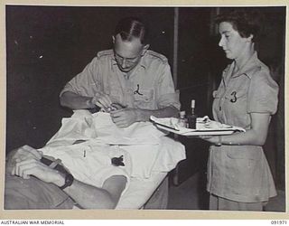 BOUGAINVILLE, 1945-04-19. CORPORAL T.A. ROBOSKY (3), AT THE EYE CLINIC, 2/1 GENERAL HOSPITAL DURING AN EYE OPERATION ON AN INJURED PUPIL
