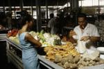 French Polynesia, merchant selling goods to customer at Papeete market