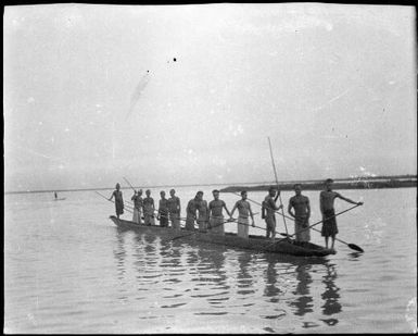 Twelve standing men paddling a canoe, Kambaramba Lake, Sepik River, New Guinea, 1935, 3 / Sarah Chinnery