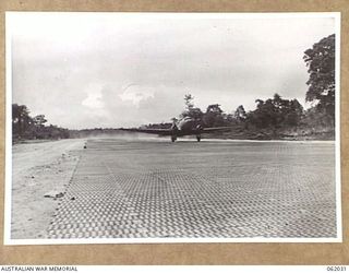 DREGER HARBOUR, NEW GUINEA. 1943-12-07. A DOUGLAS TRANSPORT IS THE FIRST LARGE AIRCRAFT TO LAND ON THE NEW STRIP BUILT BY THE 870TH UNITED STATES AVIATION BATTALION