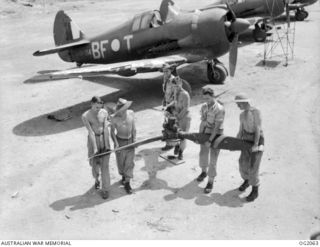 BOUGAINVILLE ISLAND, SOLOMON ISLANDS. 1945-01-12. AIRMEN OF NO. 5 (ARMY CO-OPERATION) SQUADRON RAAF AT PIVA AIRFIELD, TOROKINA, MOVING A BOOMERANG AIRCRAFT THREE-BLADED AIRSCREW TO THE WORKSHOP FOR ..