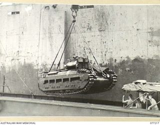 MADANG, NEW GUINEA. 1944-12-14. A "MATILDA" TANK OF THE 2/4TH ARMOURED REGIMENT BEING HOISTED ABOARD THE AMERICAN LIBERTY SHIP, "FRANCIS PARKMAN" DURING THE UNIT MOVE TO AITAPE