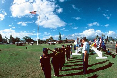 Boy Scouts and U.S. Air Force personnel honor the U.S. flag on Flag Day