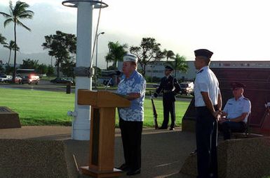 US Air Force SENIOR Airmen (SRA) Jose Olivieri of the 15th Air Base Wing Honor Guard, Hickam AFB, Hawaii, stand guard as Mr. Robert May a survivor of the attack on Pearl Harbor, describes how he survived the Japanese bombers by hiding in a manhole. US Air Force Colonel (COL) Bruce Brown (seated), Commander, 15th Air Base Wing, and USAF Major (MAJ) Joseph Davis (standing) are also in attendance