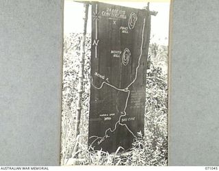 FINSCHHAFEN AREA, NEW GUINEA. 1944-03-13. ONE OF MANY BATTLE SIGNS IN THE FINSCHHAFEN AREA, THIS SIGN RECORDS ACTIVITIES OF THE 24TH INFANTRY BRIGADE