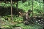Men weaving leaves
