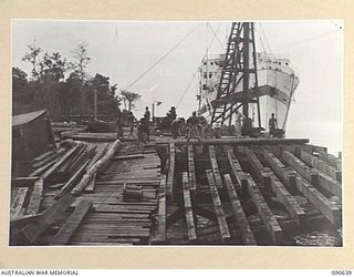 MILFORD HAVEN, LAE, NEW GUINEA. 1945-04-16. CUT AWAY PORTION OF THE COLLAPSED DECK OF A LIBERTY WHARF, WHICH COLLAPSED WITHIN SIX MONTHS OF ERECTION OWING TO THE PILES BEING DAMAGED BY BORERS. ..