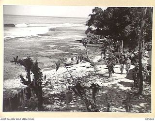 CAPE CUNNINGHAM, JACQUINOT BAY, NEW BRITAIN. 1945-09-01. PERSONNEL OF THE 8 RADAR DETACHMENT ROYAL AUSTRALIAN ARTILLERY WALKING THROUGH THEIR CAMP AREA