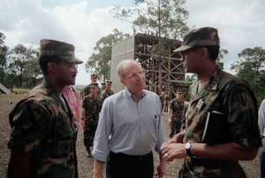 Secretary of Defense Dick Cheney and MGEN Fred A. Gorden, right, Commanding General, 25th Infantry Division (Light) talk with SGM Paul Gibson, Sergeant Major of the division's Light Infantry Training Center, during Cheney's visit to the center