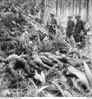 1942-12-28. PAPUA. BODIES OF FOUR DEAD JAPANESE, KILLED IN THE BUNA ACTION, LYING BESIDE A LARGE PILLBOX. THESE WERE DEFENDED BY THE JAPANESE TO THE LAST MAN, AND WITHOUT THE AUSTRALIAN-MANNED ..