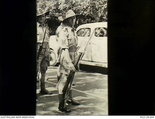 Melbourne, Vic. c. 1940-07. 2/22nd Battalion member Sergeant Herbert William (Bert) Smith holding a .303 rifle, participating in a march before he embarked for active service in Rabaul in July ..