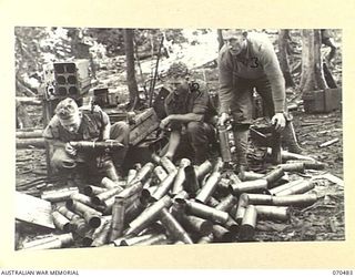 KANKIRYO SADDLE, FINISTERRE RANGE, NEW GUINEA, 1944-02-09. NX141830 PRIVATE H.R. BATTY (1) AND NX98921 PRIVATE W.T. HARRIS (2) MEMBERS OF THE 2/9TH INFANTRY BATTALION, WITH V35538 SIGNALMAN L.J. ..