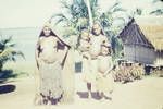 Lake Murray people, two women and two children, one of the woman is wearing a full-length mourning cape, [Papua New Guinea], c1958