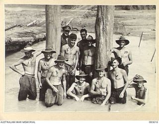 DRINIUMOR RIVER, NEW GUINEA. 1944-11-23. MEMBERS OF 4 SECTION, 7 PLATOON, 2/8 FIELD COMPANY, ROYAL AUSTRALIAN ENGINEERS, PHOTOGRAPHED ON THEIR JOB OF BRIDGING THE RIVER. THE BRIDGE IS ONE OF A ..