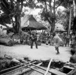 Two female clown (faaluma) perform to the delight of assembled children