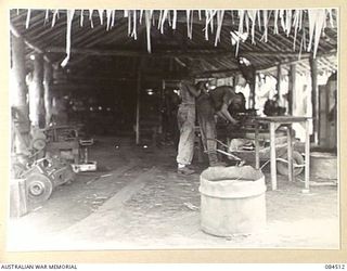 LABU, NEW GUINEA. 1944-12-18. WORKSHOPS AT 55 PORT CRAFT COMPANY STAFFED BY 3 LANDING CRAFT WORKSHOP PERSONNEL. THIS WORKSHOP IS CAPABLE OF CARRYING 3RD AND 4TH ECHELON REPAIRS TO ALL EQUIPMENT ..