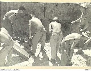 JACQUINOT BAY, NEW BRITAIN. 1944-11-17. TROOPS OF THE 472ND HEAVY ANTI-AIRCRAFT TROOP DIGGING A PIT FOR THE UNIT COMMAND POST. IDENTIFIED PERSONNEL ARE:- VX100453 LANCE BOMBARDIER WALTERS (1); ..