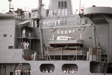 The crew of the combat stores ship USS NIAGARA FALLS (AFS 3) mans the rails upon the ship's arrival at Naval Station Guam