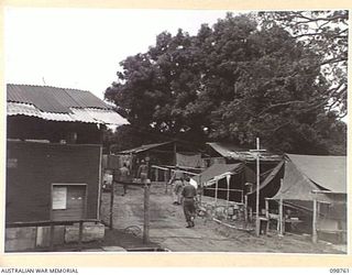 RABAUL, NEW BRITAIN. 1945-11-11. THE VISITORS' AND OBSERVERS' SECTION AT HEADQUARTERS 11 DIVISION WITH PART OF THE CAMP IN THE BACKGROUND