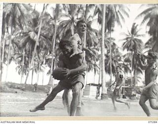 MILILAT, NEW GUINEA. 1944-08-20. AN EXCITING INCIDENT DURING THE BASKETBALL MATCH BETWEEN HEADQUARTERS 5TH DIVISION AND A TEAM FROM THE HMAS "MANOORA". IDENTIFIED PERSONNEL ARE:- ABLE SEAMAN C.E. ..