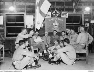 MEMBERS OF THE FIRST PAPUAN SERVICES CREW, (ROVERS), AT THEIR GENERAL MEETING IN ST. JOHN'S CHURCH. THE BANNER AT THE BACKGROUND HAS BEEN SIGNED BY ALL MEMBERS FOR FORWARDING TO THE NEW SOUTH WALES ..