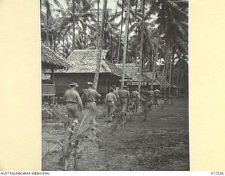 MILNE BAY, NEW GUINEA. 1944-04-20. THE HONOURABLE E.J. WARD, MINISTER FOR EXTERNAL TERRITORIES IN THE AUSTRALIAN GOVERNMENT WITH HIS OFFICIAL PARTY INSPECTING THE OTHER RANKS' LINES, AUSTRALIAN NEW ..