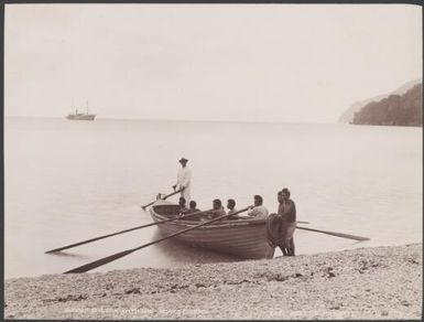 Bishop Wilson with his boats crew at a Melanesian island, Southern Cross in background, 1906 / J.W. Beattie